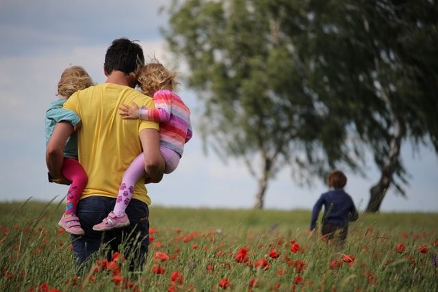 Father walking with young children after being granted Child Arrangement Order