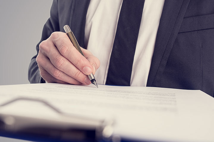 An individual signing a document.