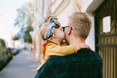 A father holding his baby in his arms.