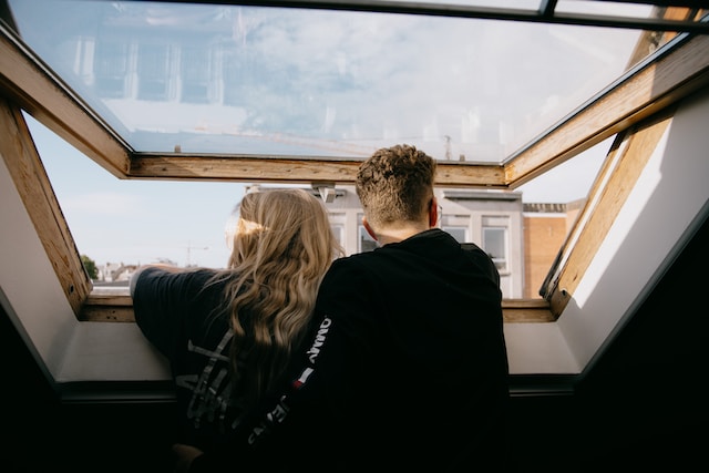 A couple look out of their skylight window together